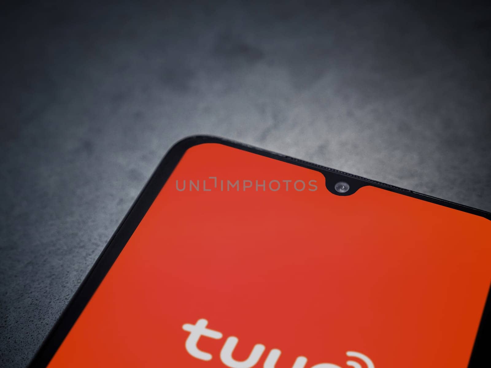 Lod, Israel - July 16,2023: Tuya Smart app launch screen on smartphone on dark marble stone background. Top view flat lay with copy space.