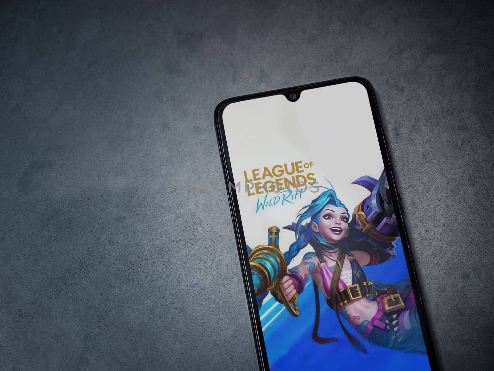 Lod, Israel - July 16,2023: League of Legends - Wild Rift app launch screen on smartphone on dark marble stone background. Top view flat lay with copy space.