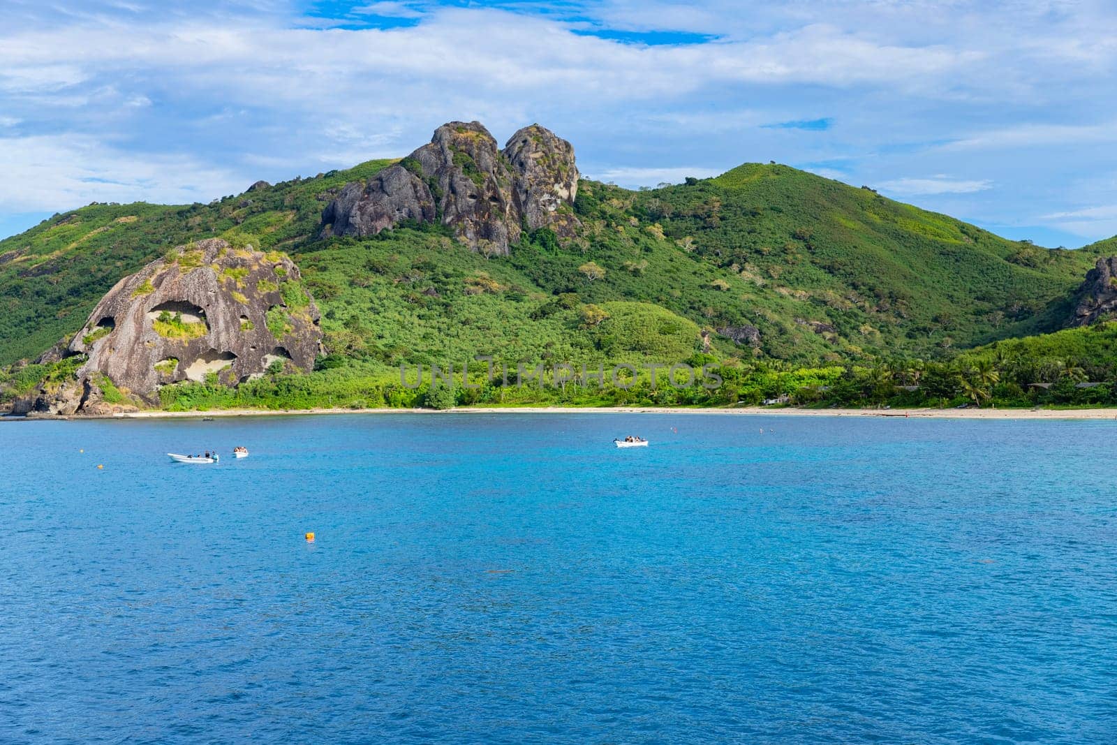 Nacula, Fiji: 26 May 2023: Tourist boats at the tropical island of Naviti, Yasawa Islands, Fiji. This archipelago consists of about 20 volcanic islands