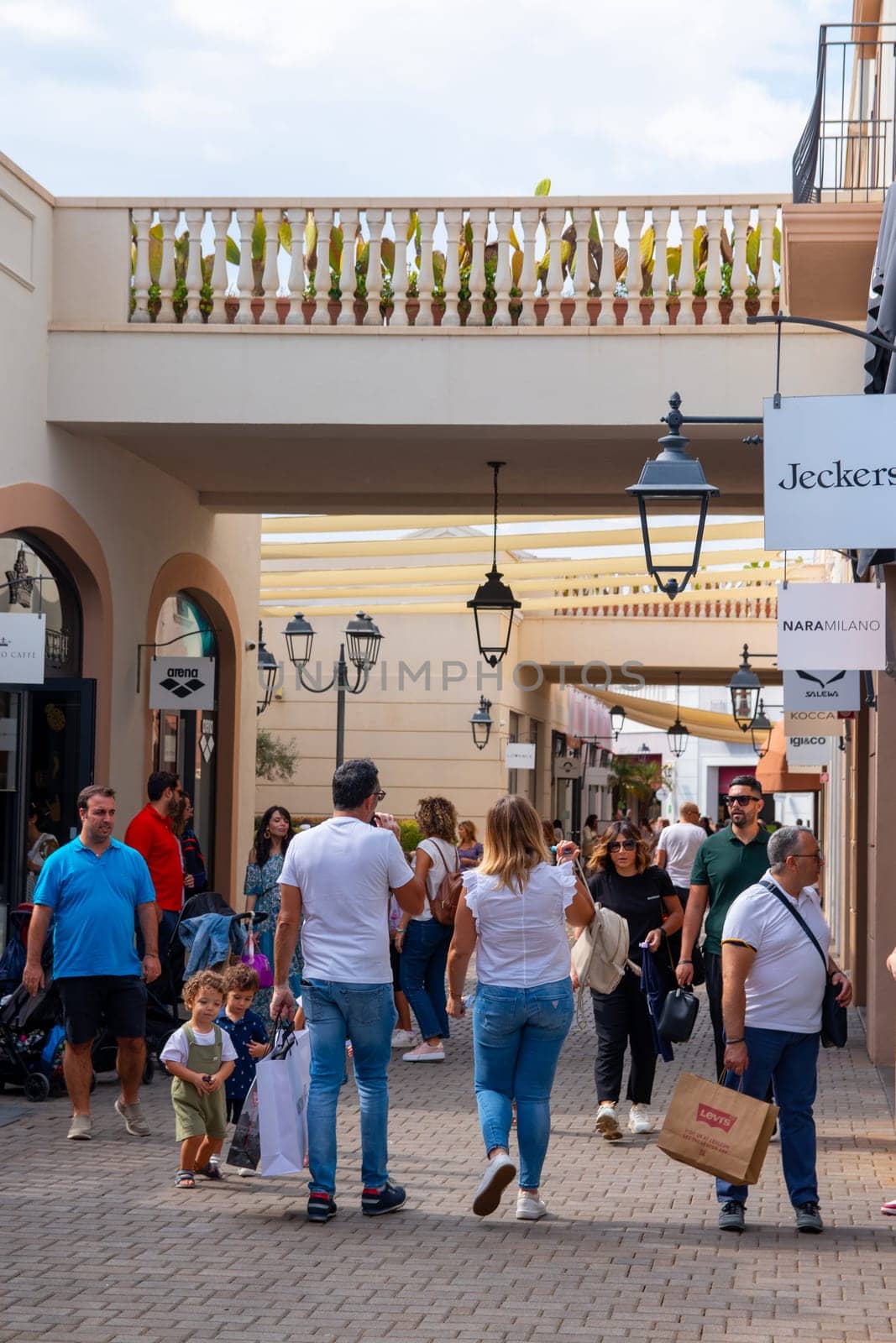 Agira, Sicily, Italy - 30 Sep 2023. Sicilia Outlet Village shopping centre is a popular visitor magnet. People shopping at Sicilia Outlet Village.