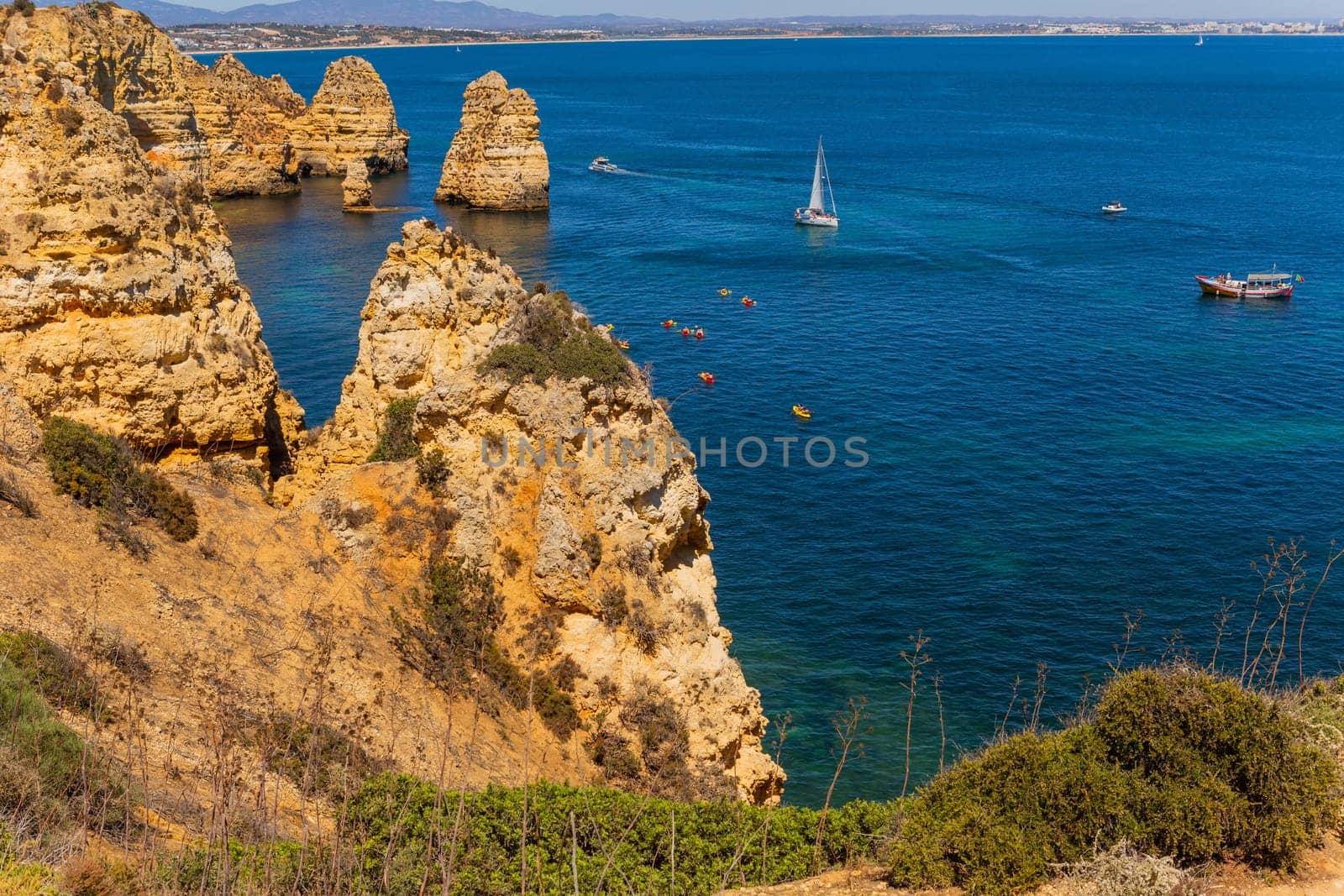 Lagos, Portugal - 25 August 2025: Tourists visiting Ponta da Piedade, in Lagos. Algarve, Portugal