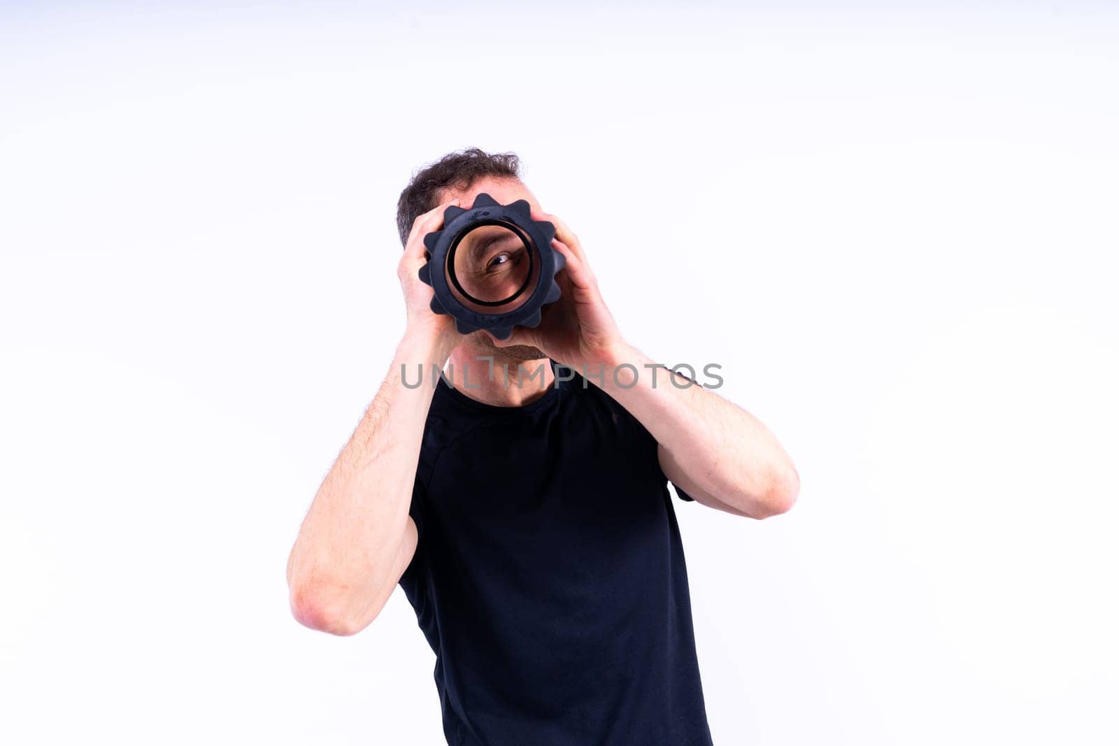 Athletic man using a foam roller to relieve sore muscles after workout.
