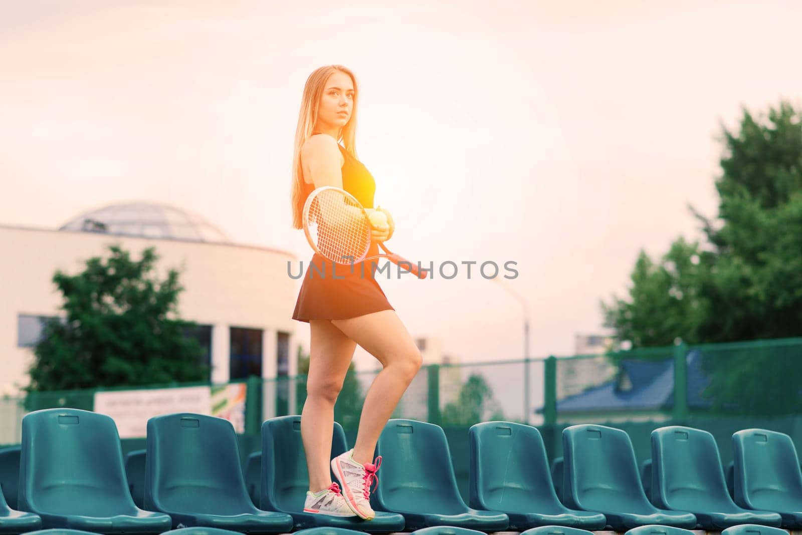 Tennis tournament. Female player at clay tennis court