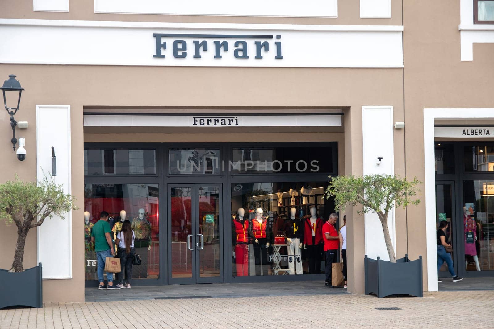 Sicily, Italy, Agira - 30 Sep 2023. The Sicilia Outlet Village shopping centre is a popular visitor magnet. Passage with front of the Ferrari boutique