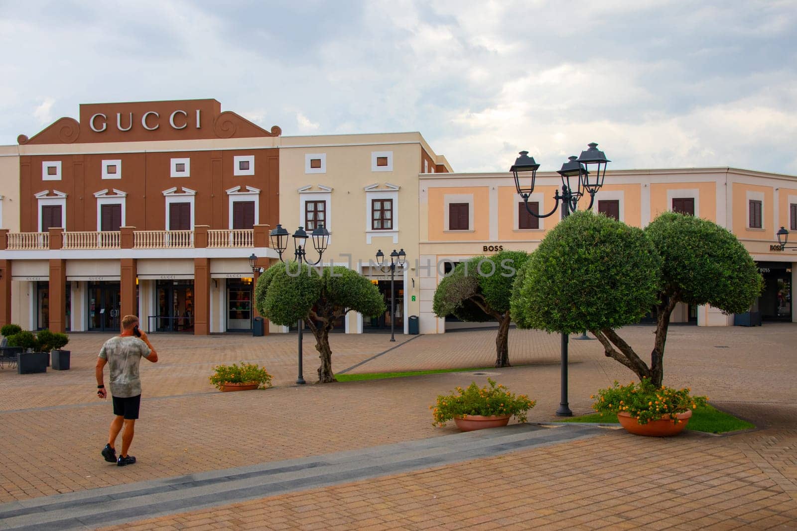 Sicily, Agira, Italy - 30 Sep 2023. Sicilia Outlet Village shopping centre is a popular visitor magnet. Place with buildings of Gucci and Boss boutique.