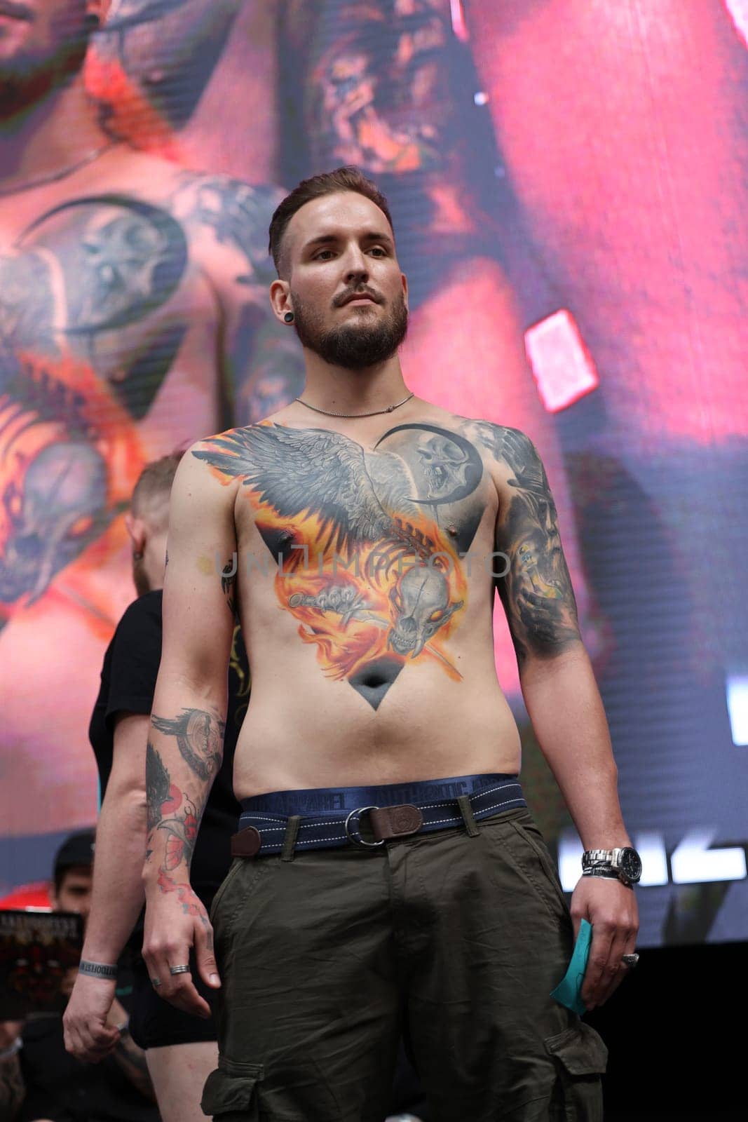 Krakow, Poland - June 12, 2022: Unidentified participant during the contest for the best tattoo at the 15th Tattoofest Convention in Cracow. One of the most prestigious tattoo festivals.