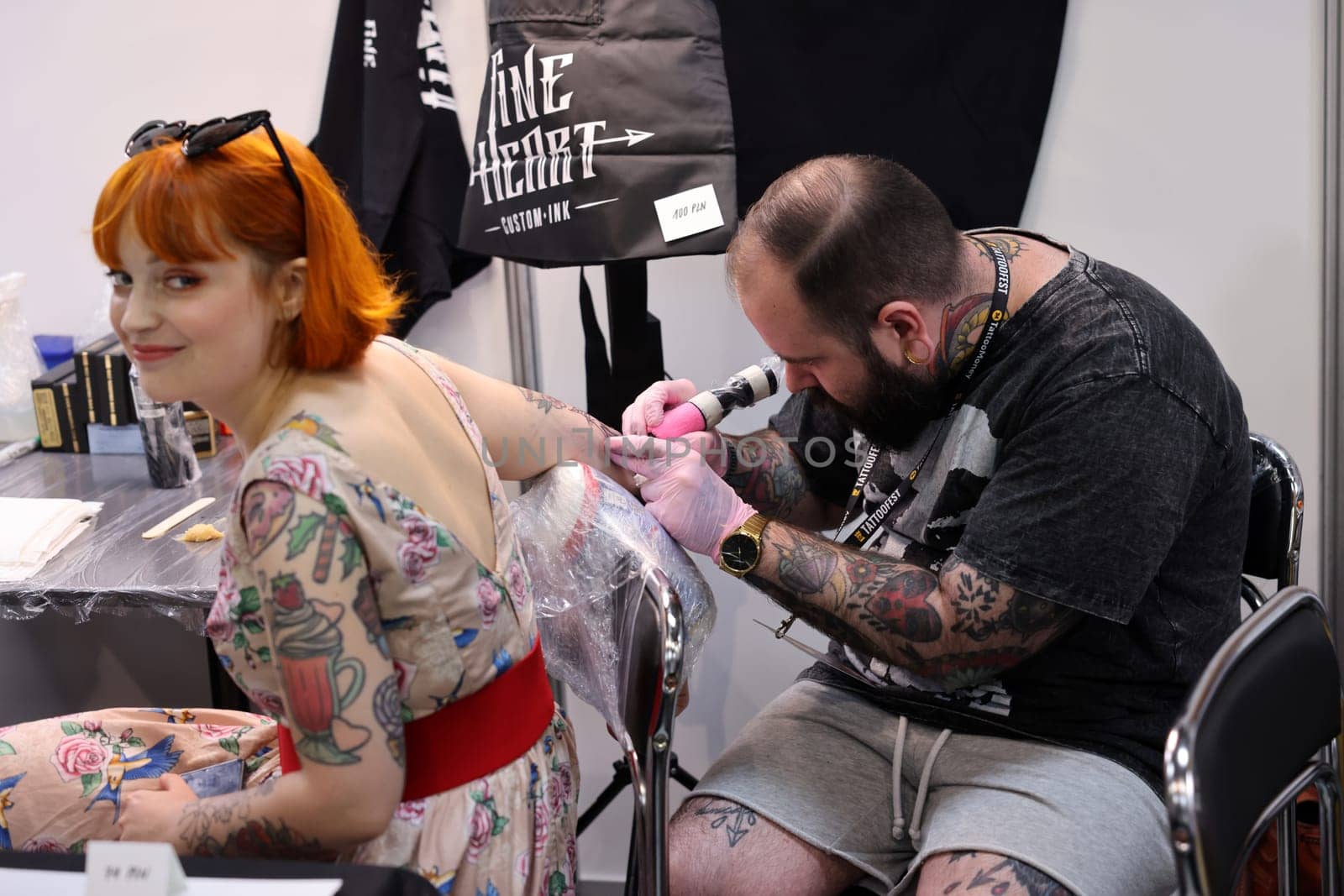 Krakow, Poland -  June 12, 2022: Unidentified  participant at 15th Tattoofest Convention in Cracow. Tattoo artist at work.