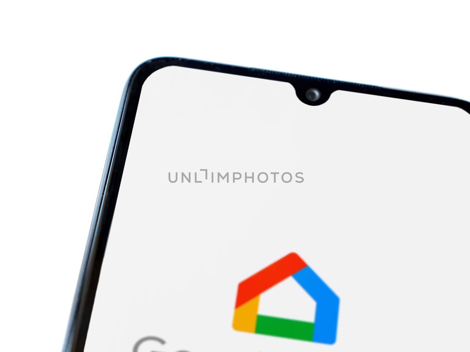Lod, Israel - July 16,2023: Google Home app launch screen on smartphone on white background. Top view flat lay with copy space.