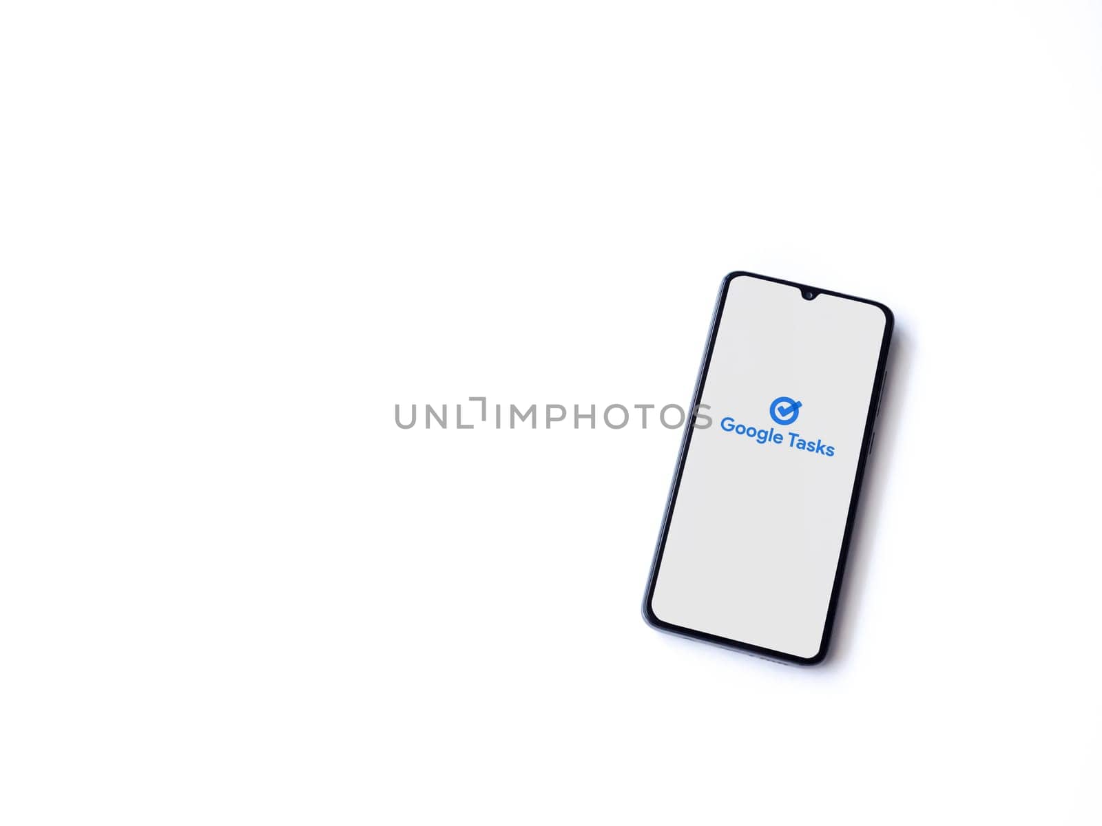 Lod, Israel - July 16,2023: Google Task app launch screen on smartphone on white background. Top view flat lay with copy space.