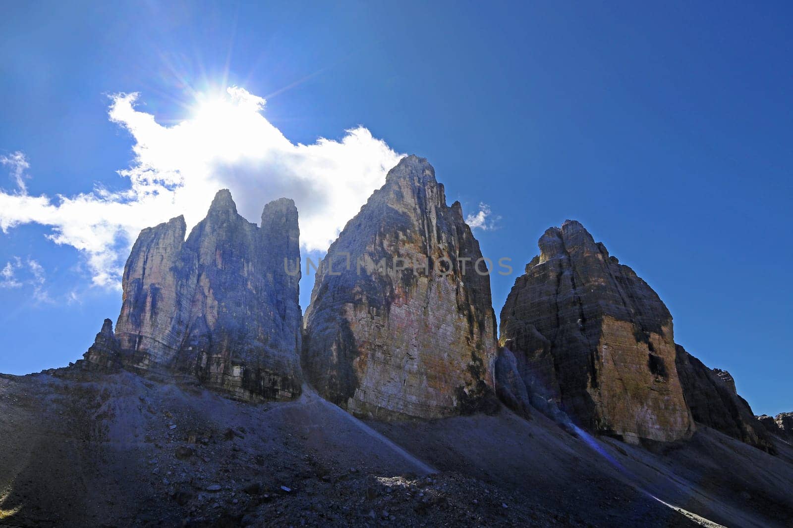 The famous Three Peaks in the Dolomites in the back light of the sun