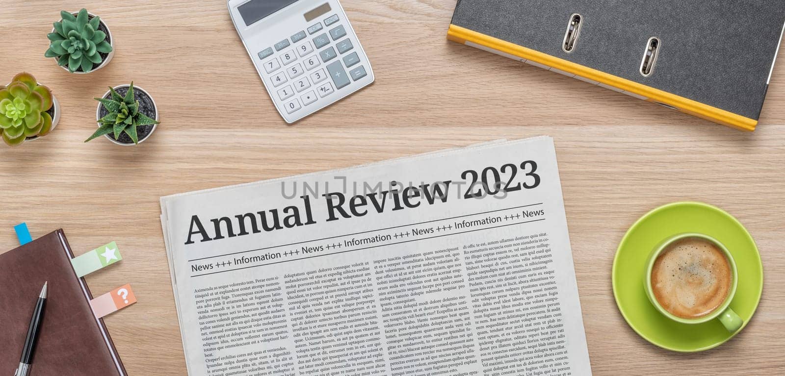 A newspaper on a desk with the headline Annual review 2023