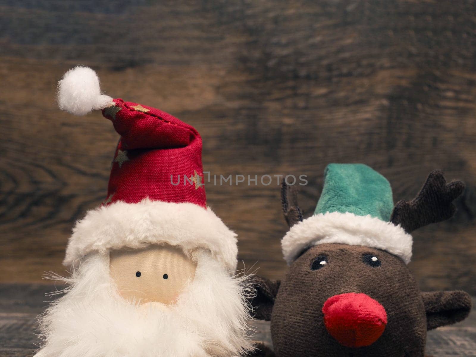 Santa and reindeer  on a wooden background with space for text, Christmas or seasonal greetings card backdrop