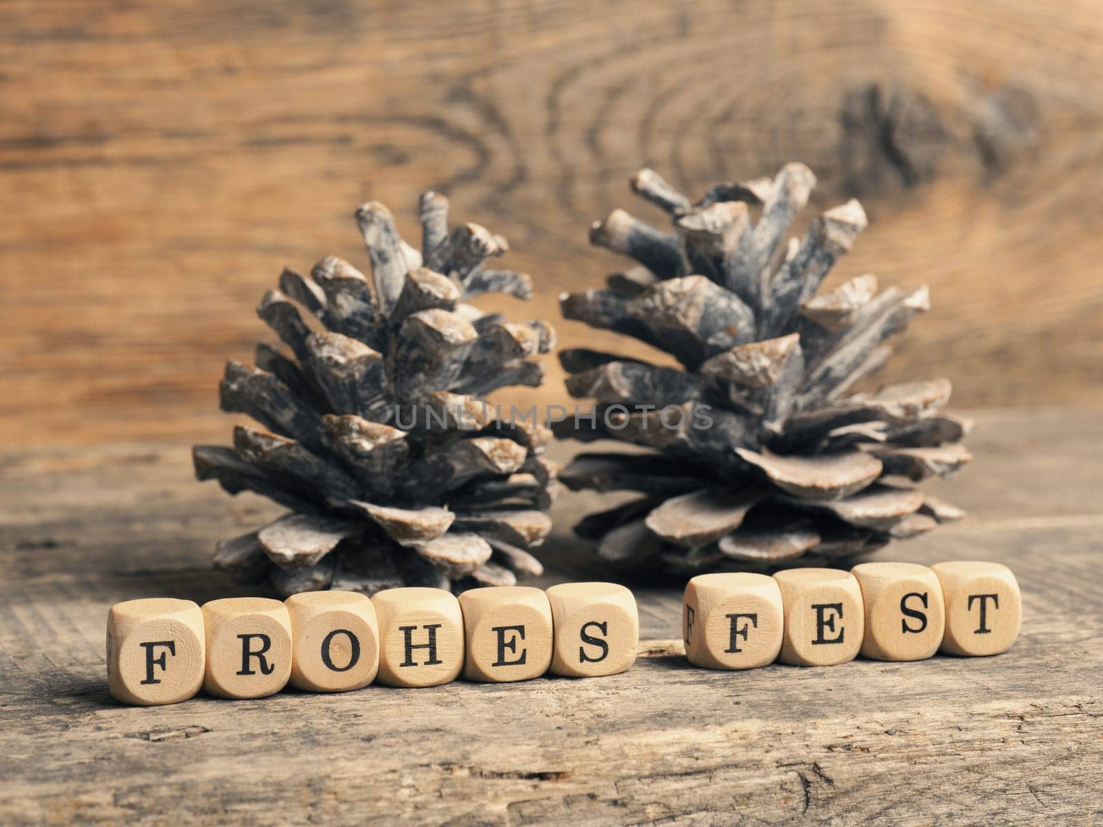 German Merry Christmas with wooden blocks and the inscrption Frohes fest, seasonal greetings