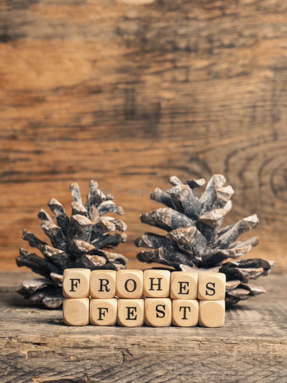 German Merry Christmas with wooden blocks and the inscrption Frohes fest, seasonal greetings