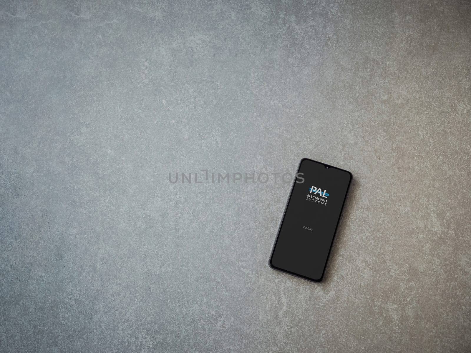 Lod, Israel - July 16,2023: PalGate app launch screen on smartphone on ceramic stone background. Top view flat lay with copy space.