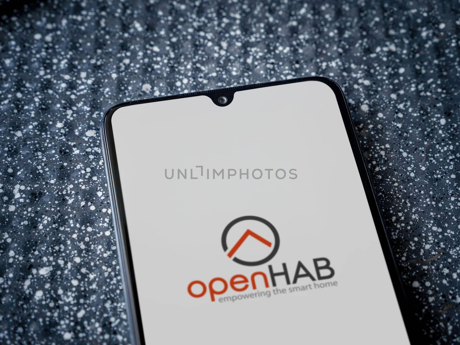 Lod, Israel - July 16,2023: openHAB app launch screen on smartphone on metallic background. Close up top view flat lay.