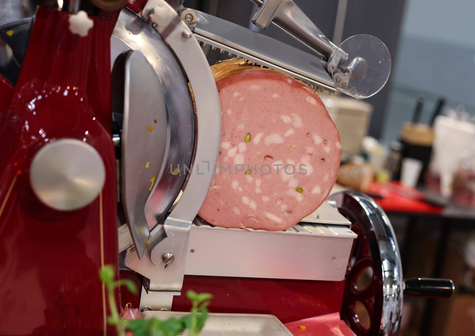 Mortadella ready to be cut on a professional slicer