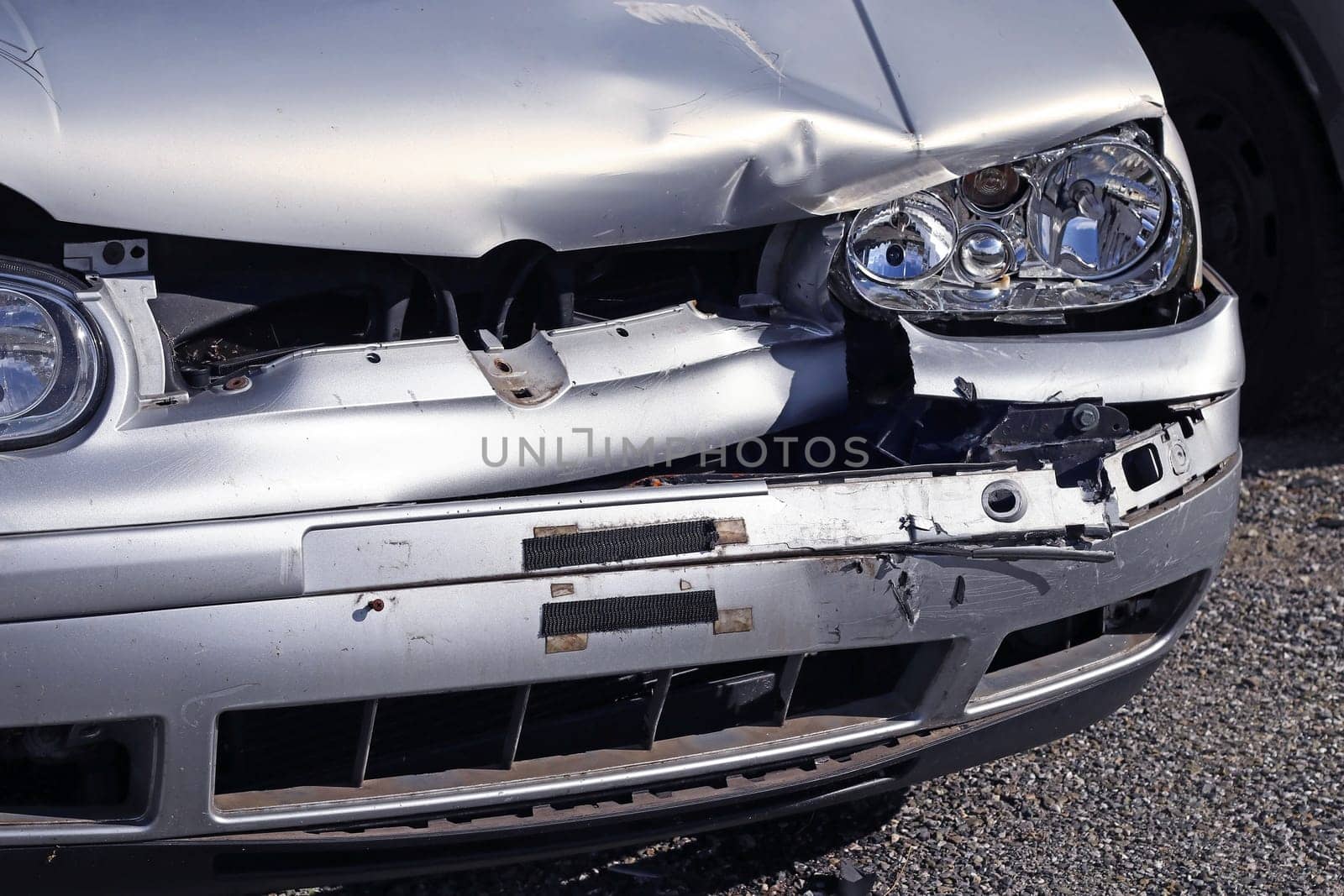 Silver car damaged by traffic accident
