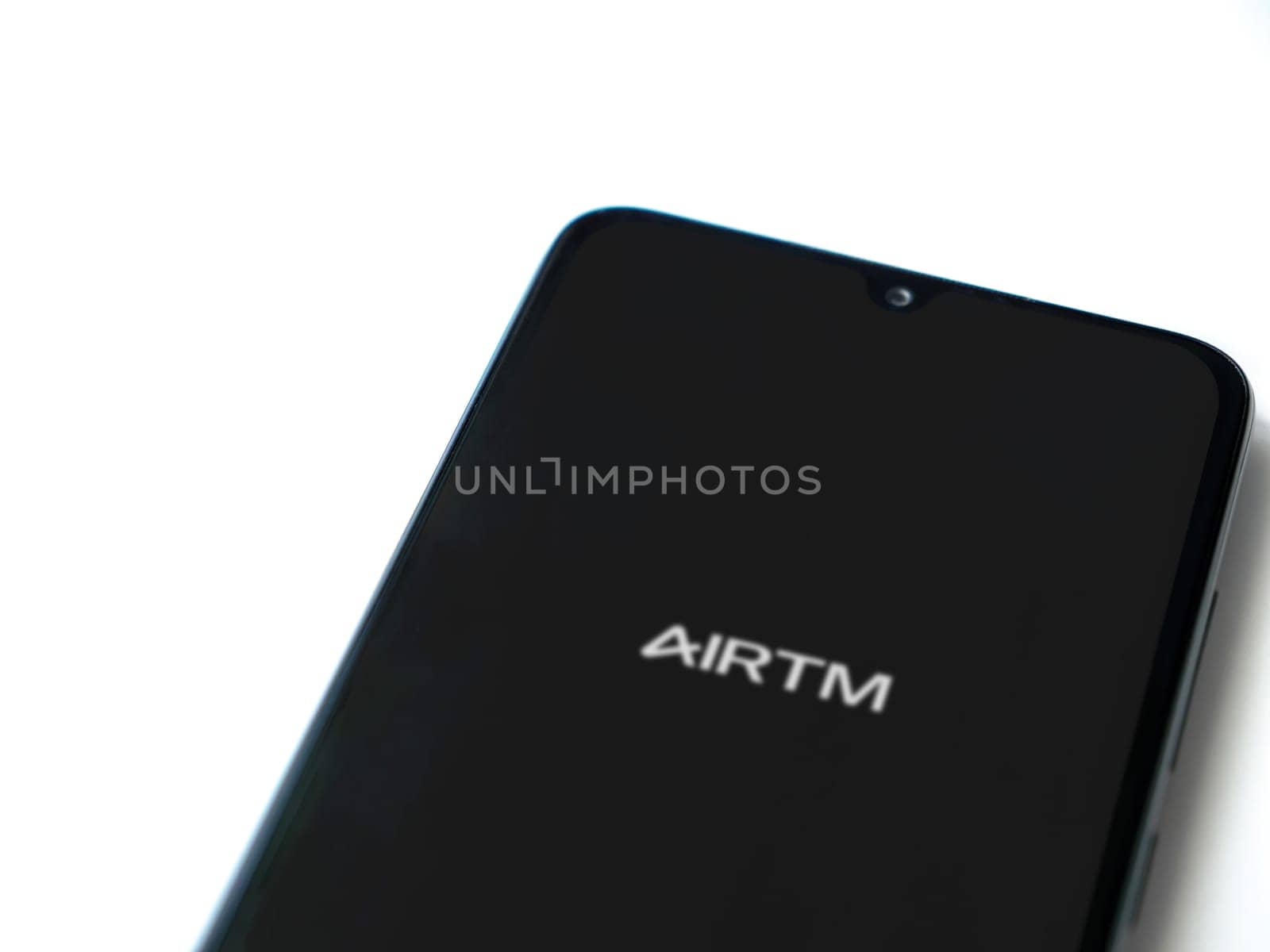 Lod, Israel - July 16,2023: AirTM app launch screen on smartphone on white background. Top view flat lay with copy space.