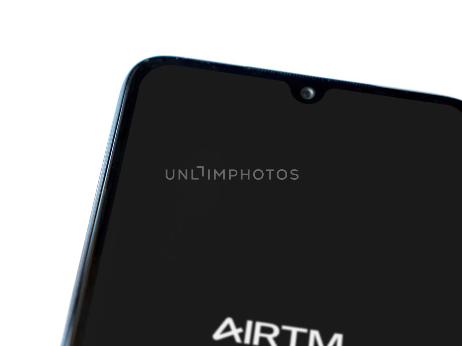 Lod, Israel - July 16,2023: AirTM app launch screen on smartphone on white background. Top view flat lay with copy space.