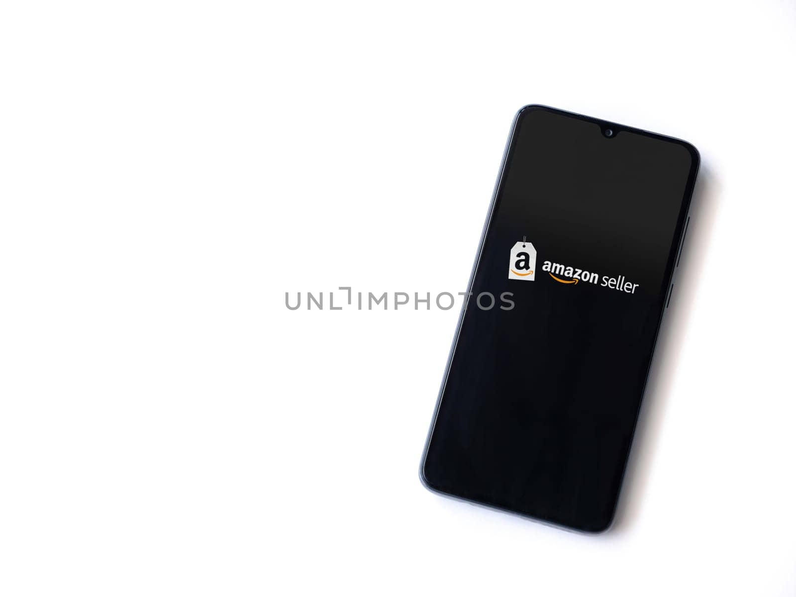 Lod, Israel - July 16,2023: Amazon Seller app launch screen on smartphone on white background. Top view flat lay with copy space.