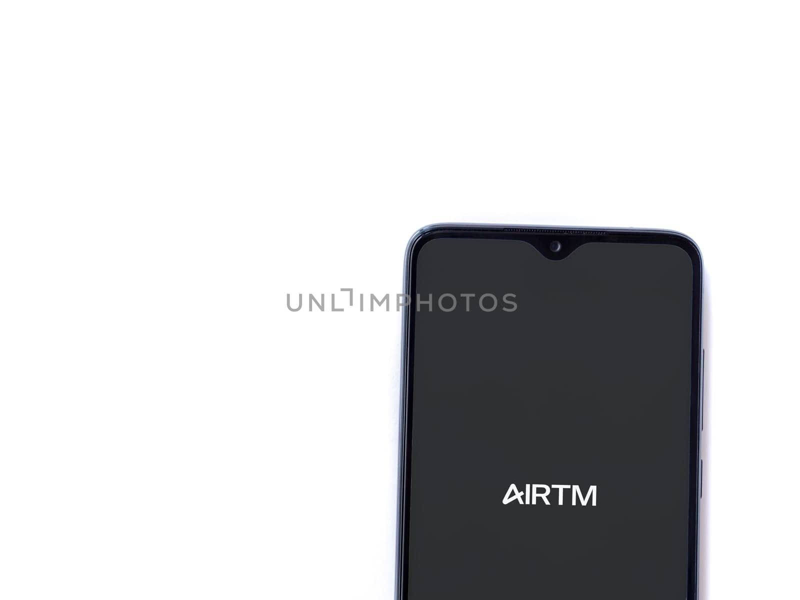 Lod, Israel - July 16,2023: AirTM app launch screen on smartphone on white background. Top view flat lay with copy space.