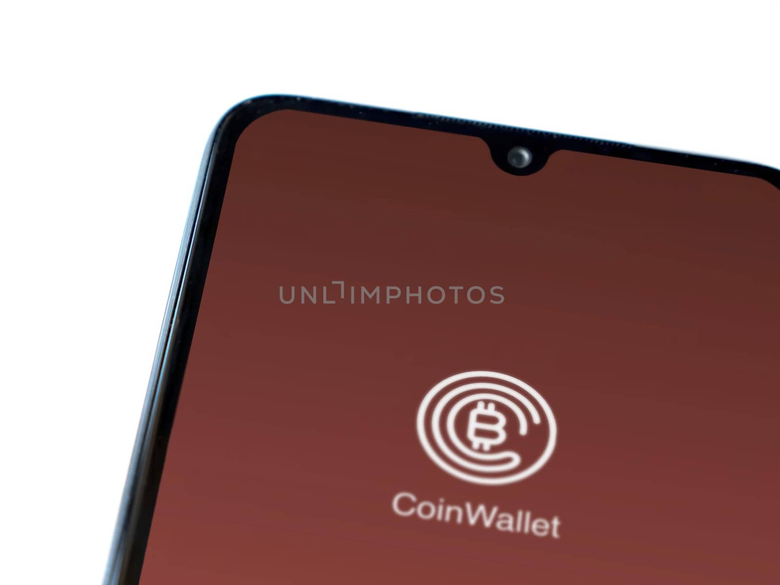 Lod, Israel - July 16,2023: CoinWallet app launch screen on smartphone on white background. Top view flat lay with copy space.