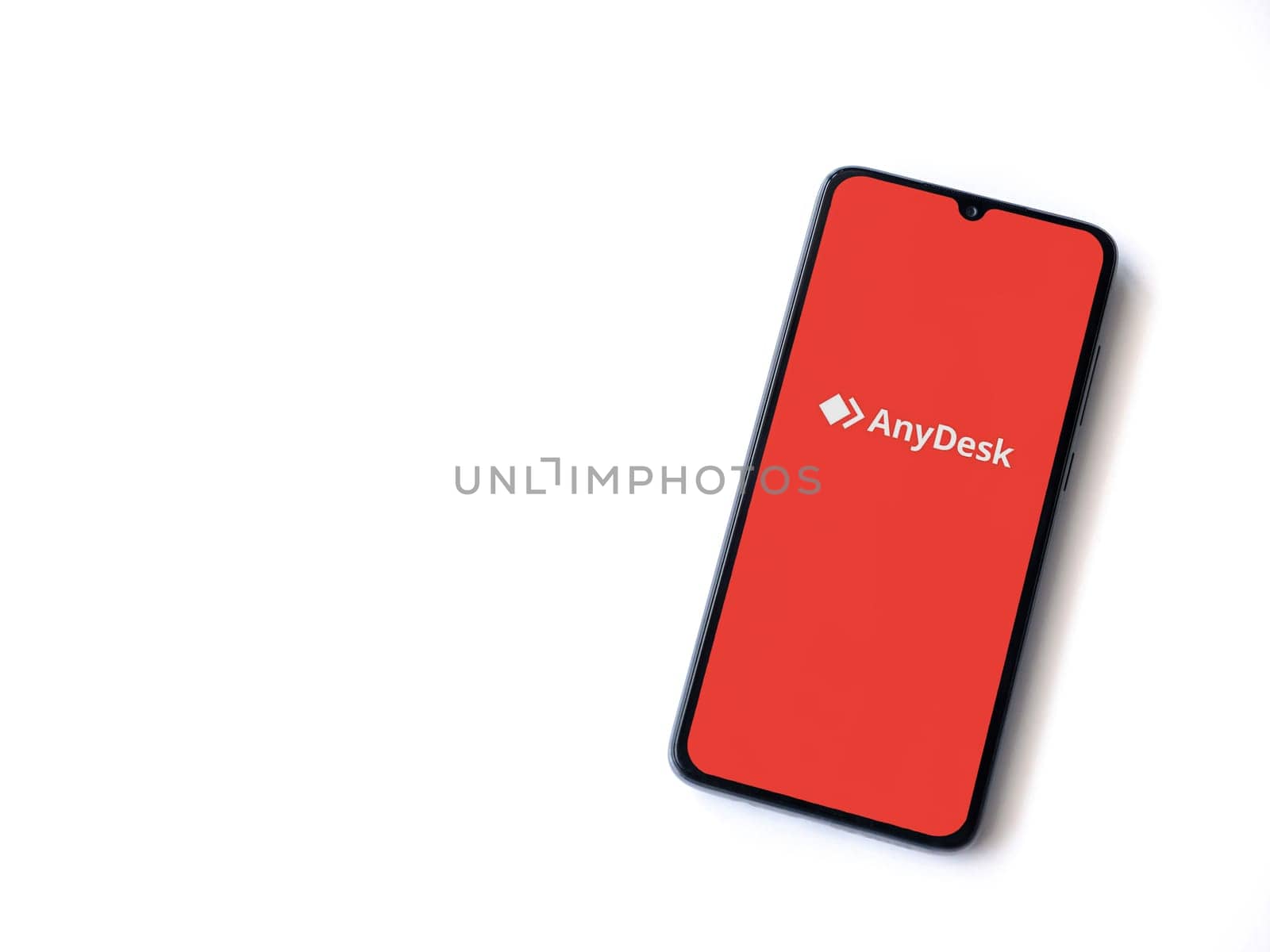 Lod, Israel - July 16,2023: Anydesk app launch screen on smartphone on white background. Top view flat lay with copy space.