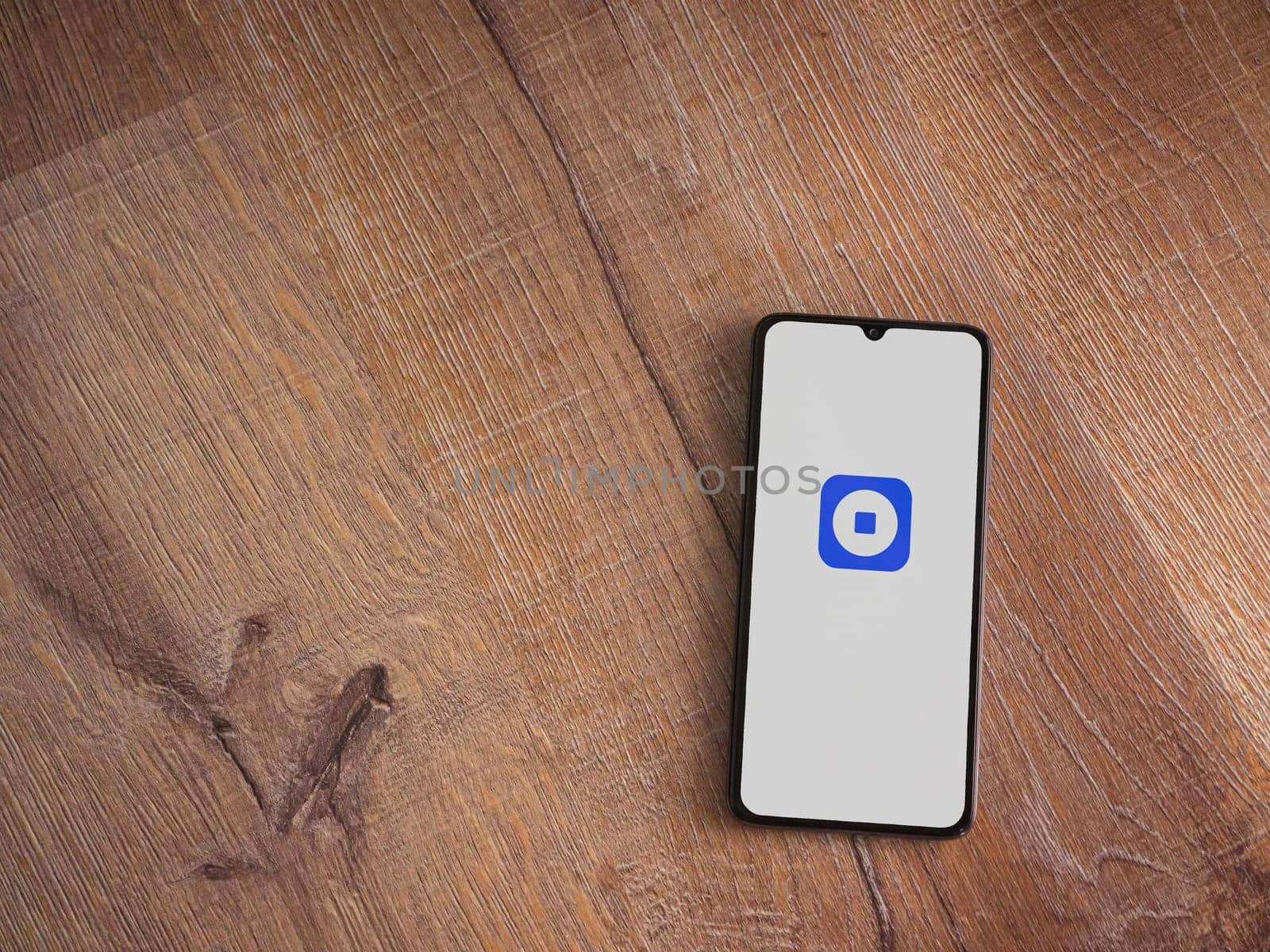 Lod, Israel - July 16,2023: Coinbase Wallet app launch screen on smartphone on wooden background. Top view flat lay with copy space.