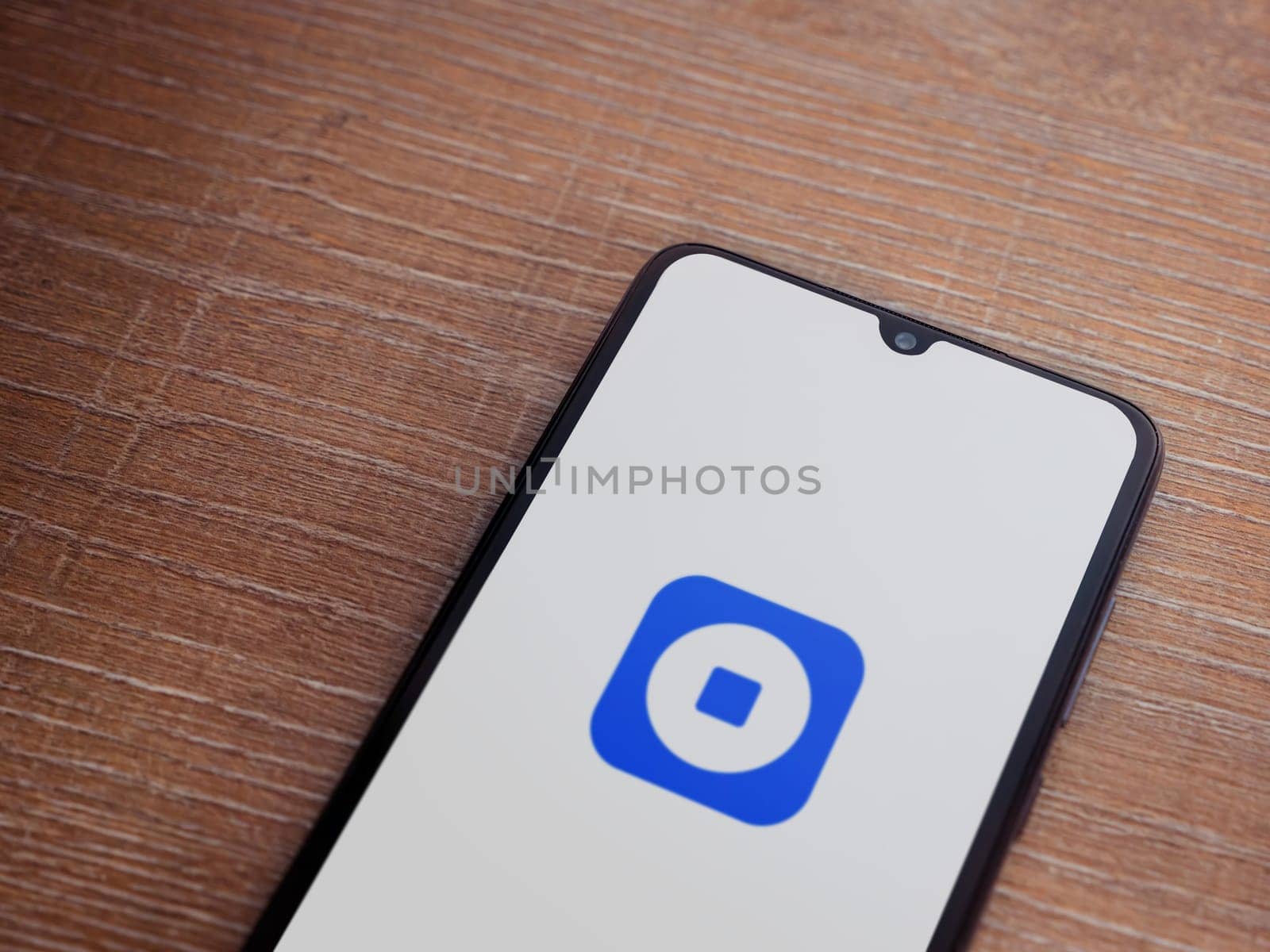 Lod, Israel - July 16,2023: Coinbase Wallet app launch screen on smartphone on wooden background. Top view flat lay with copy space.