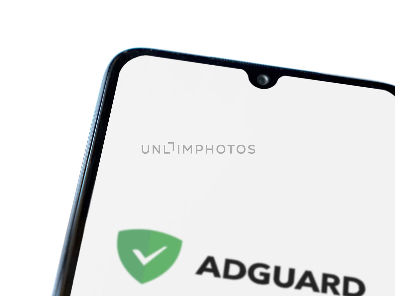 Lod, Israel - July 16,2023: AdGuard app launch screen on smartphone on white background. Top view flat lay with copy space.