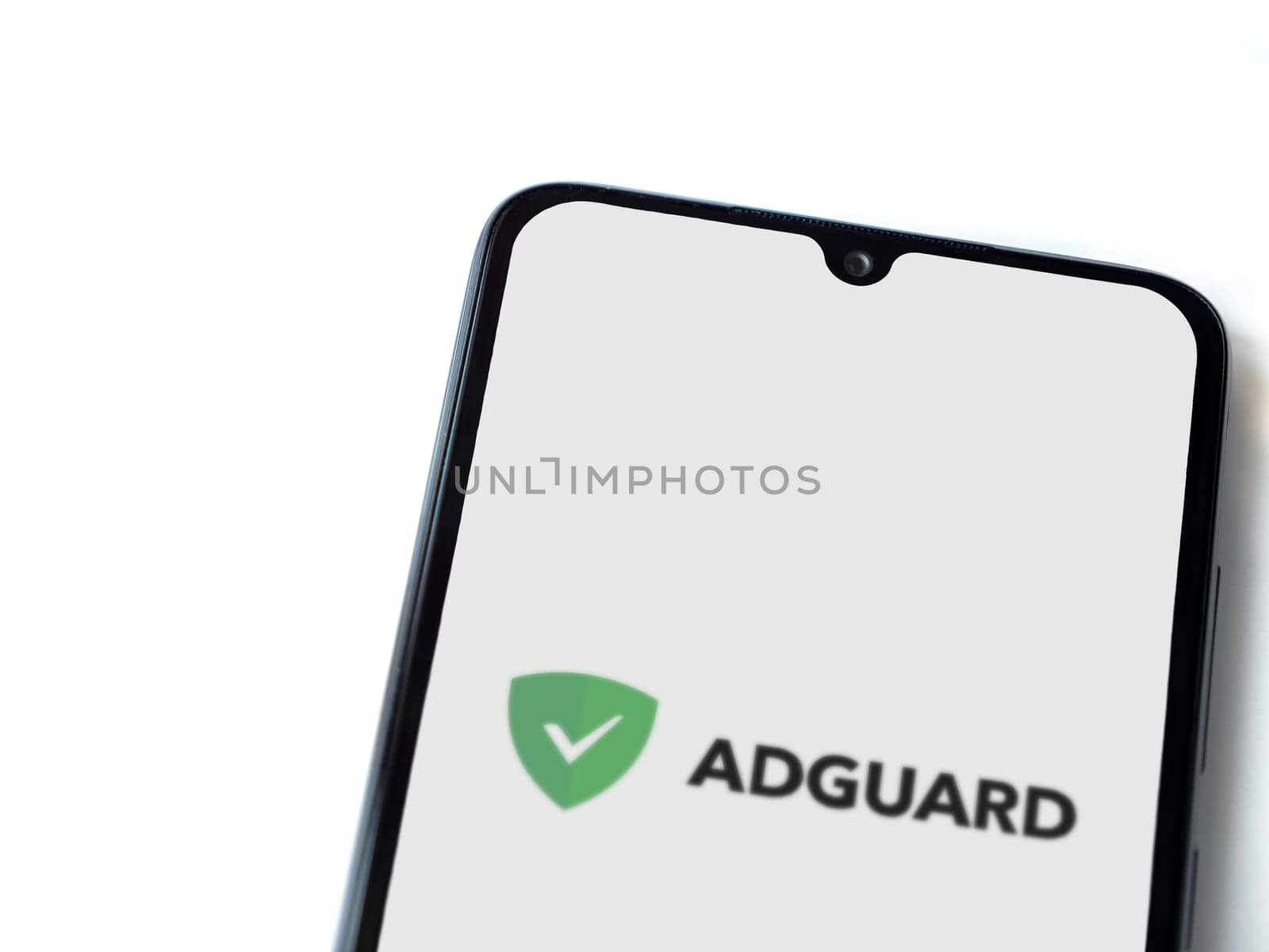 Lod, Israel - July 16,2023: AdGuard app launch screen on smartphone on white background. Top view flat lay with copy space.