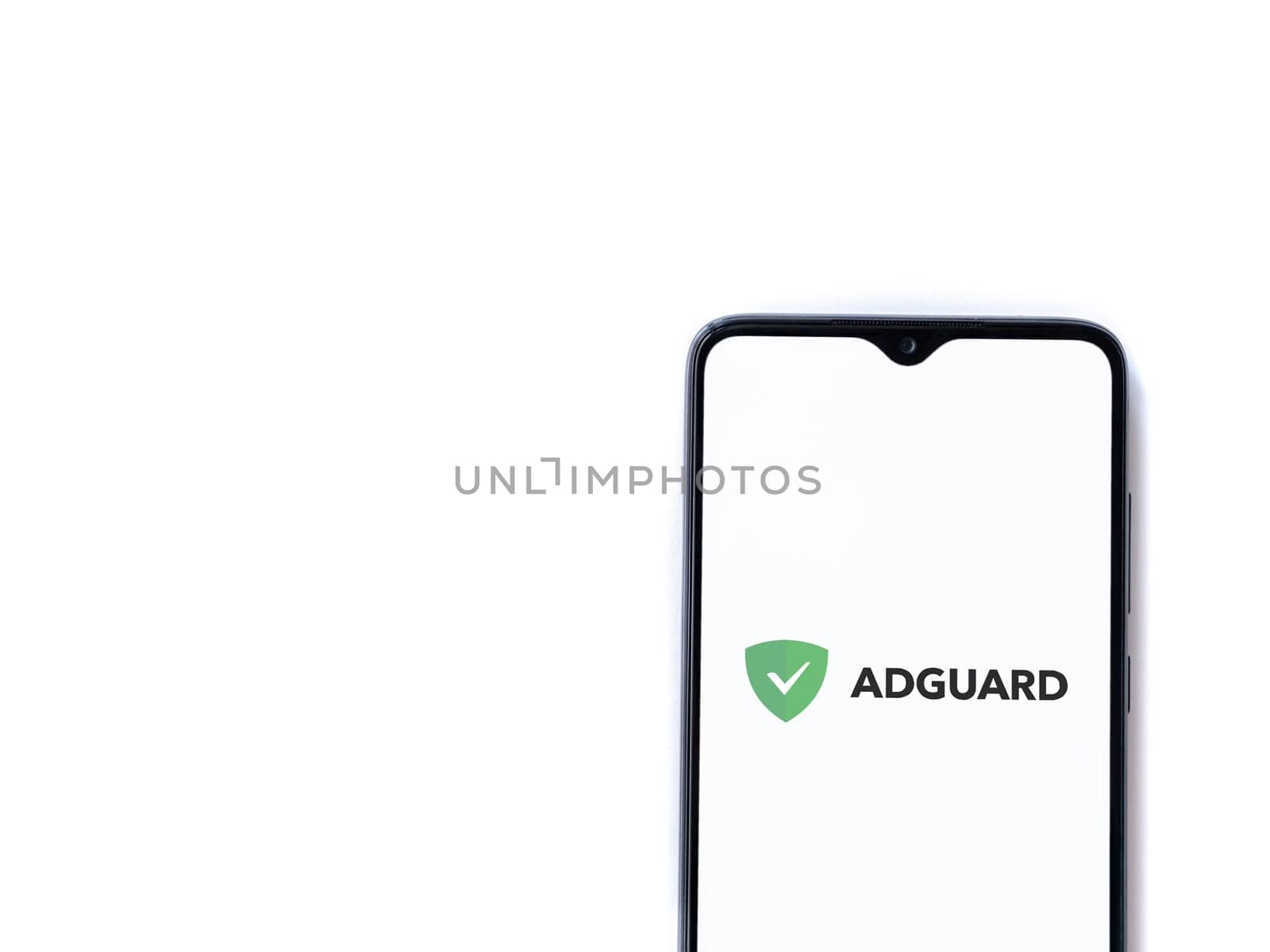 Lod, Israel - July 16,2023: AdGuard app launch screen on smartphone on white background. Top view flat lay with copy space.