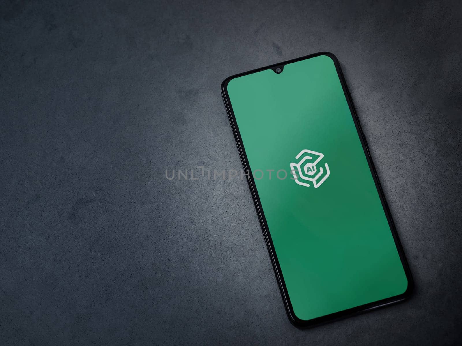 Lod, Israel - July 16,2023: Adam Ai app launch screen on smartphone on dark marble stone background. Top view flat lay with copy space.