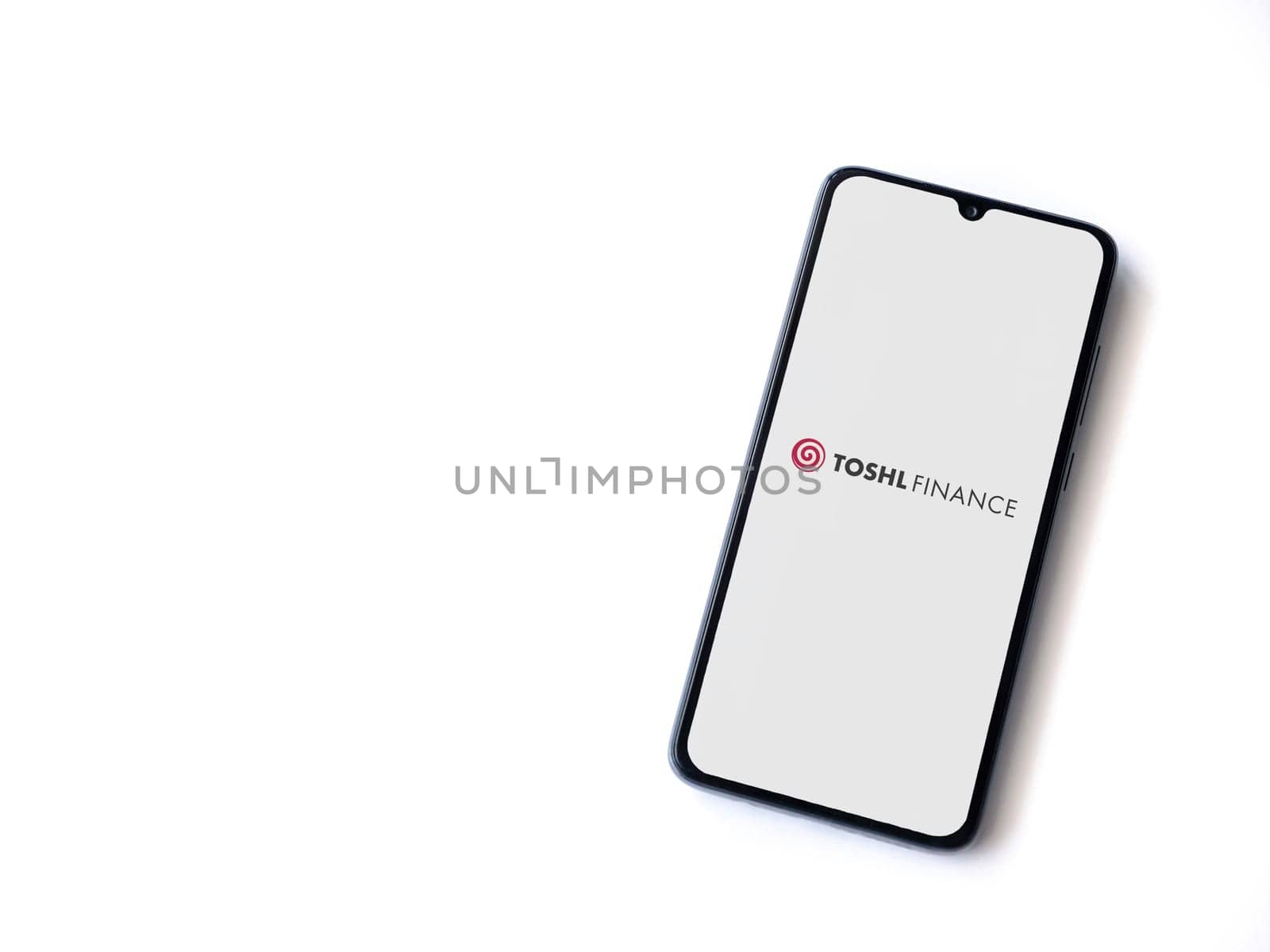 Lod, Israel - July 16,2023: Toshl Finance app launch screen on smartphone on white background. Top view flat lay with copy space.