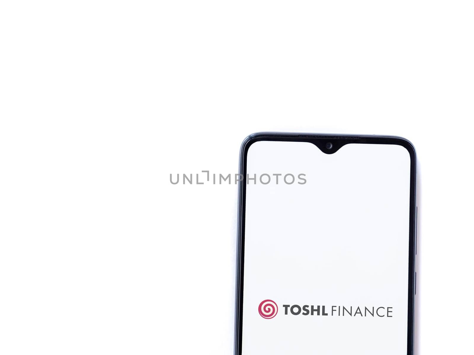 Lod, Israel - July 16,2023: Toshl Finance app launch screen on smartphone on white background. Top view flat lay with copy space.