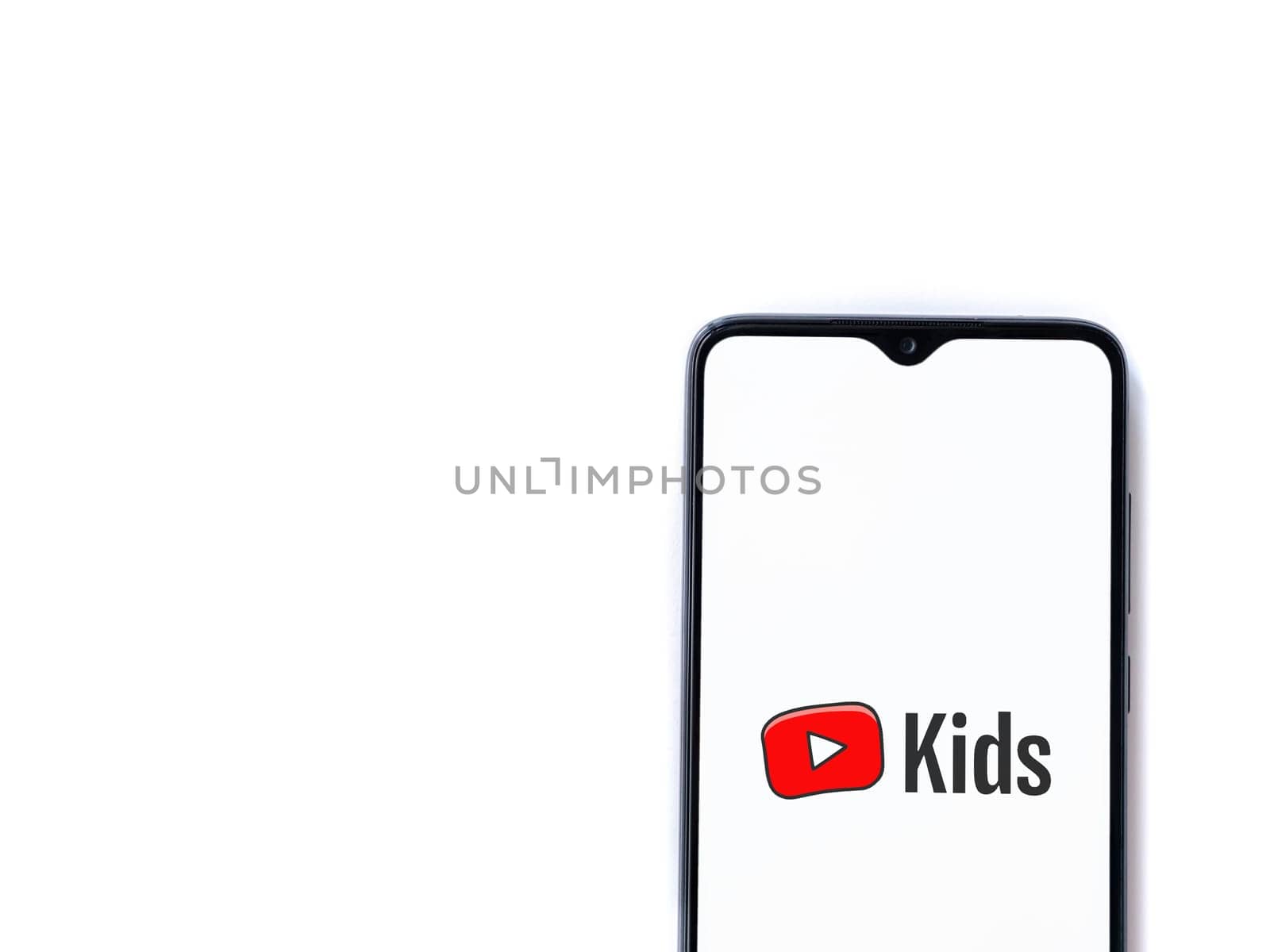 Lod, Israel - July 16,2023: YouTube Kids app launch screen on smartphone on white background. Top view flat lay with copy space.