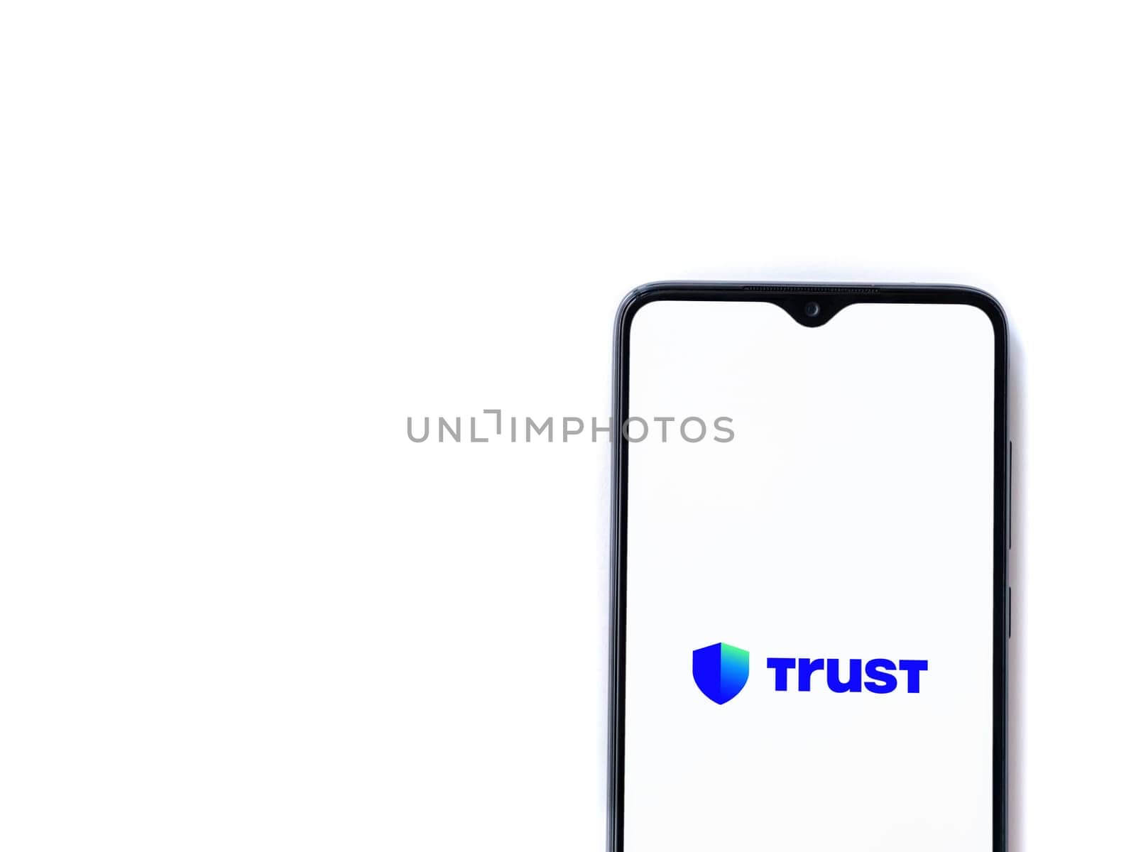 Lod, Israel - July 16,2023: Trust Wallet app launch screen on smartphone on white background. Top view flat lay with copy space.