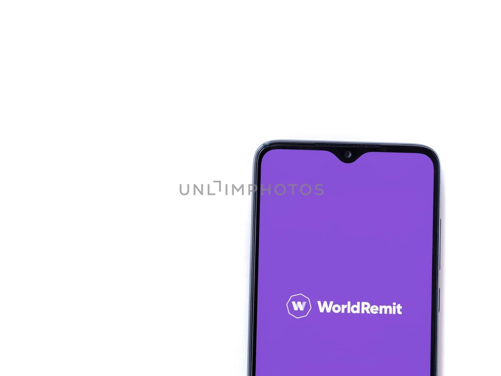 Lod, Israel - July 16,2023: WorldRemit app launch screen on smartphone on white background. Top view flat lay with copy space.