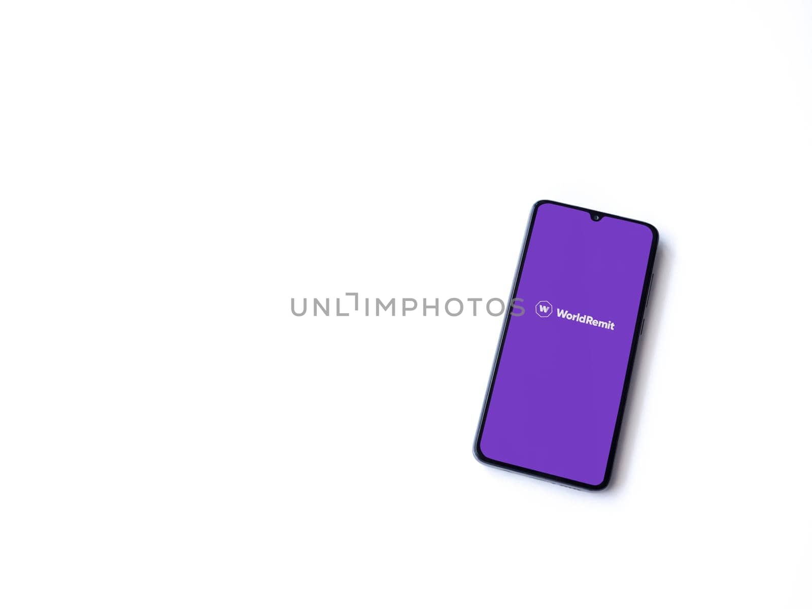 Lod, Israel - July 16,2023: WorldRemit app launch screen on smartphone on white background. Top view flat lay with copy space.
