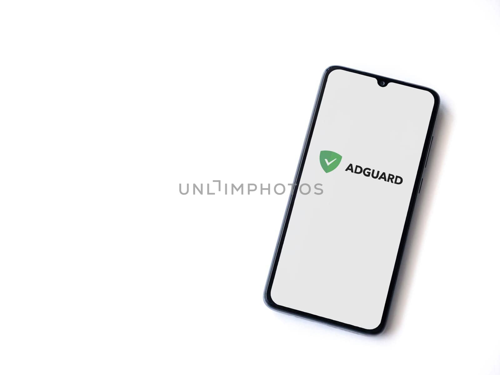 Lod, Israel - July 16,2023: AdGuard app launch screen on smartphone on white background. Top view flat lay with copy space.