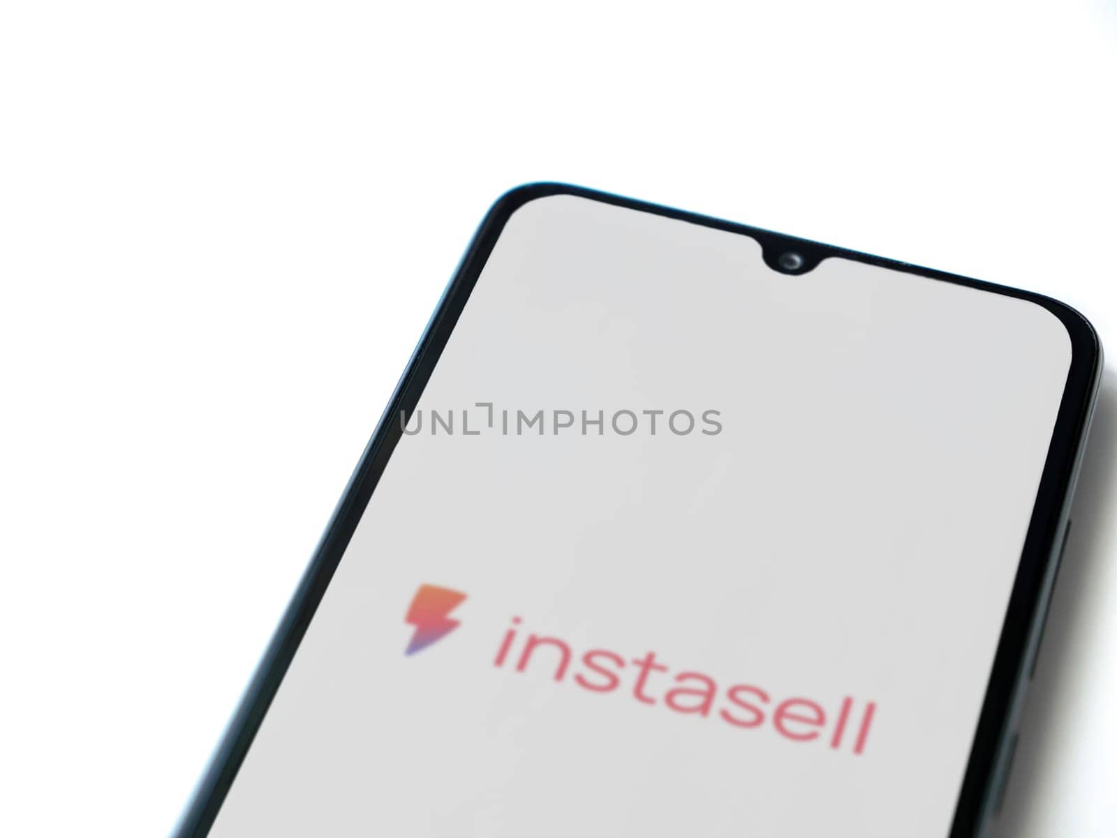 Lod, Israel - July 16,2023: Instasell app launch screen on smartphone on white background. Top view flat lay with copy space.