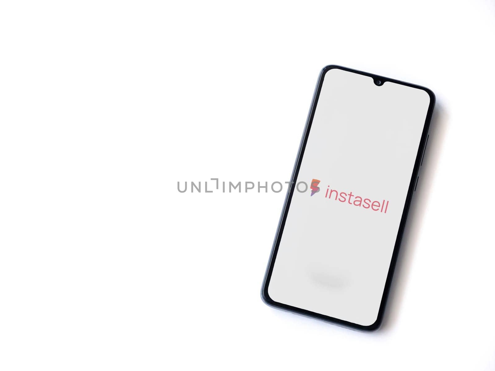 Lod, Israel - July 16,2023: Instasell app launch screen on smartphone on white background. Top view flat lay with copy space.