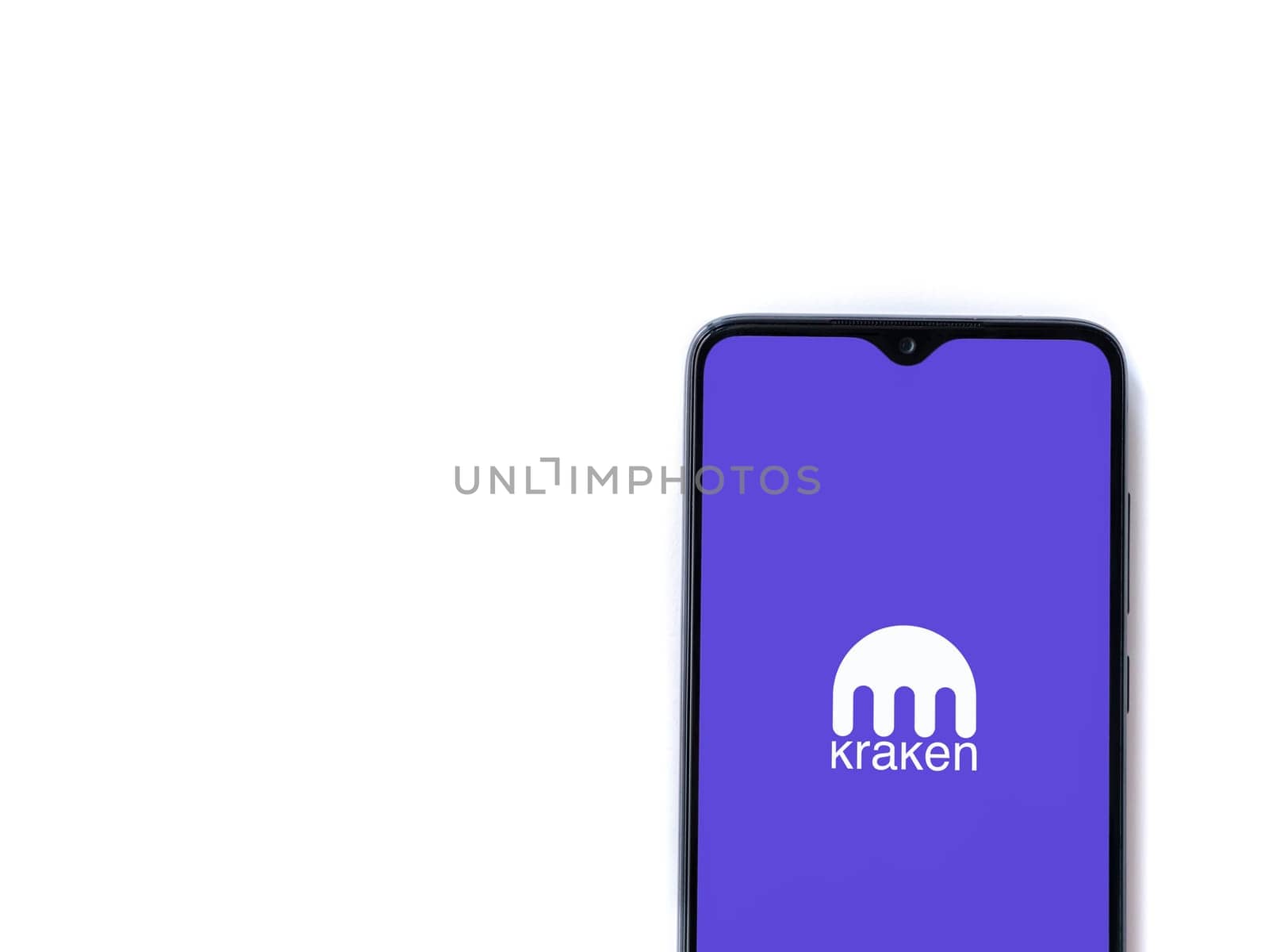Lod, Israel - July 16,2023: Kraken app launch screen on smartphone on white background. Top view flat lay with copy space.