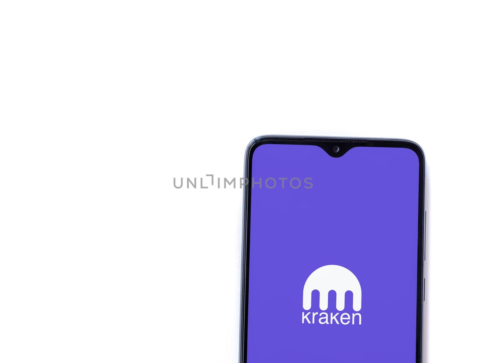 Lod, Israel - July 16,2023: Kraken app launch screen on smartphone on white background. Top view flat lay with copy space.