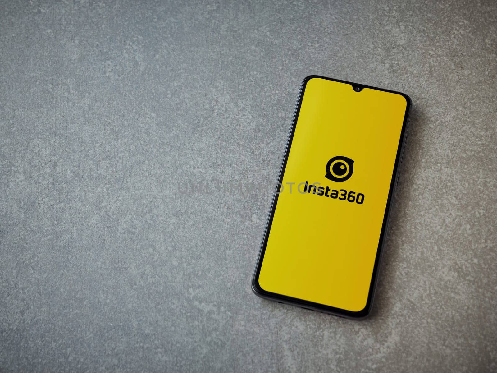 Lod, Israel - July 16,2023: Insta360 app launch screen on smartphone on ceramic stone background.. Top view flat lay with copy space.