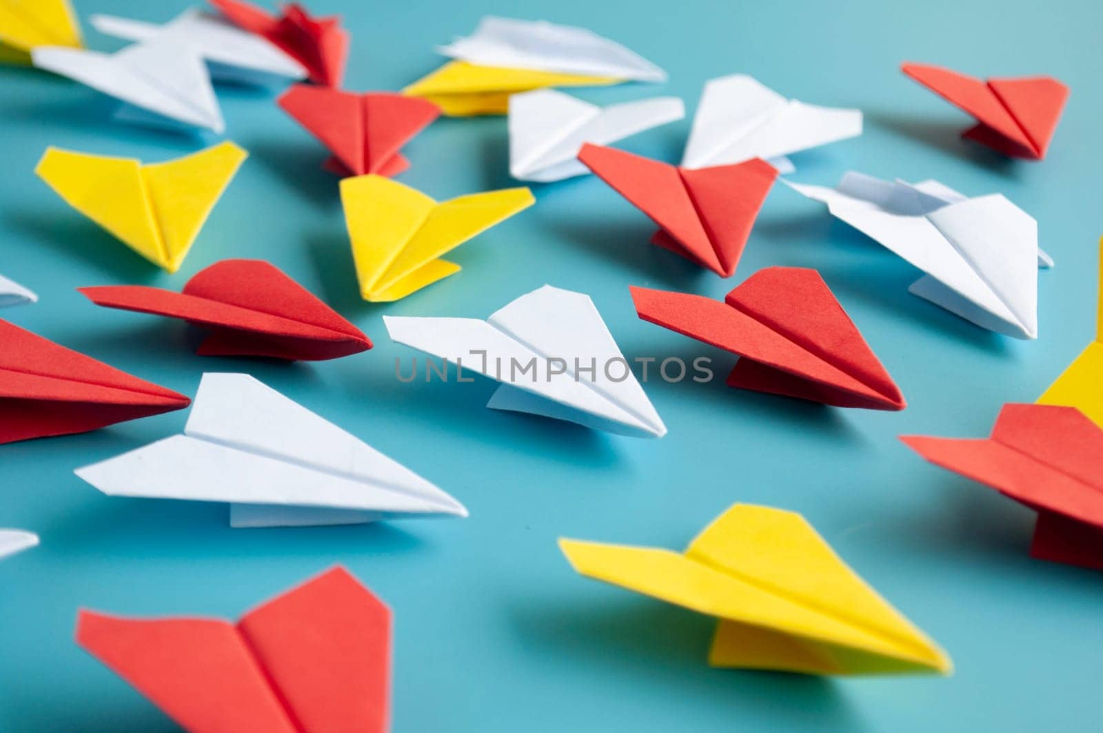 Low view of yellow paper plane origami leading white paper planes. With copy space for text