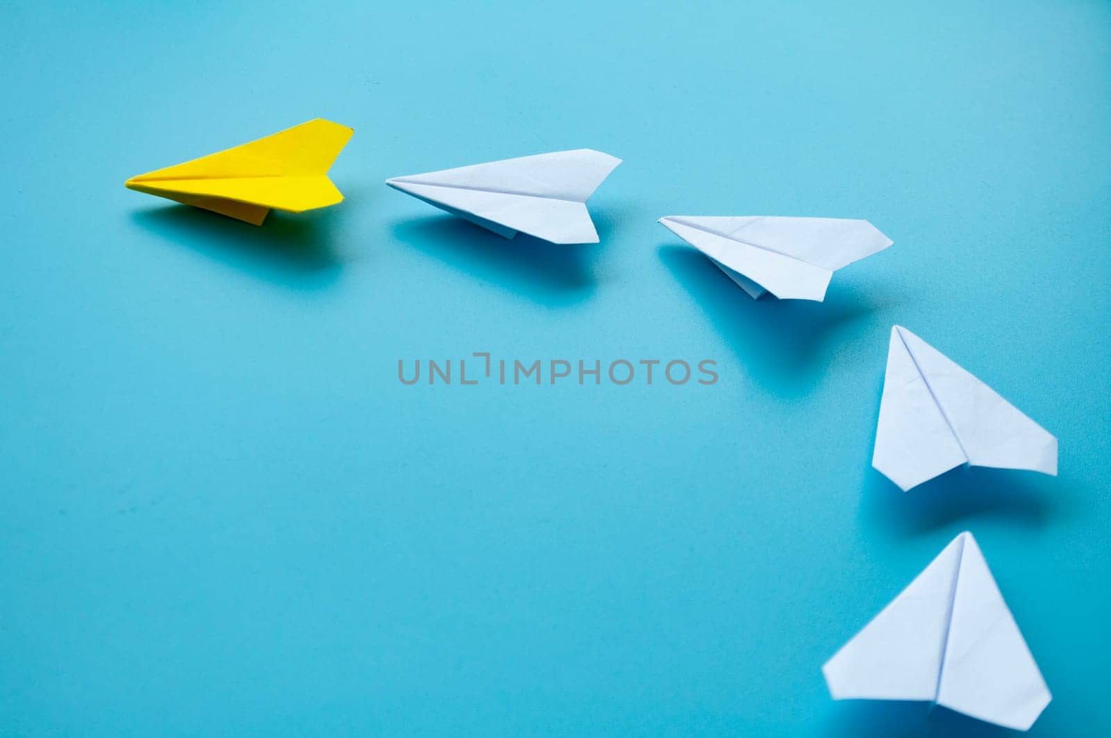 Top view of yellow paper airplanes with space for text.
