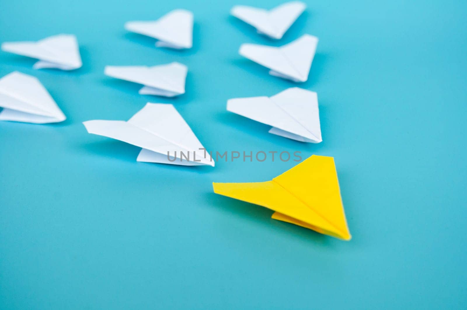 Top view of yellow paper airplanes with space for text.