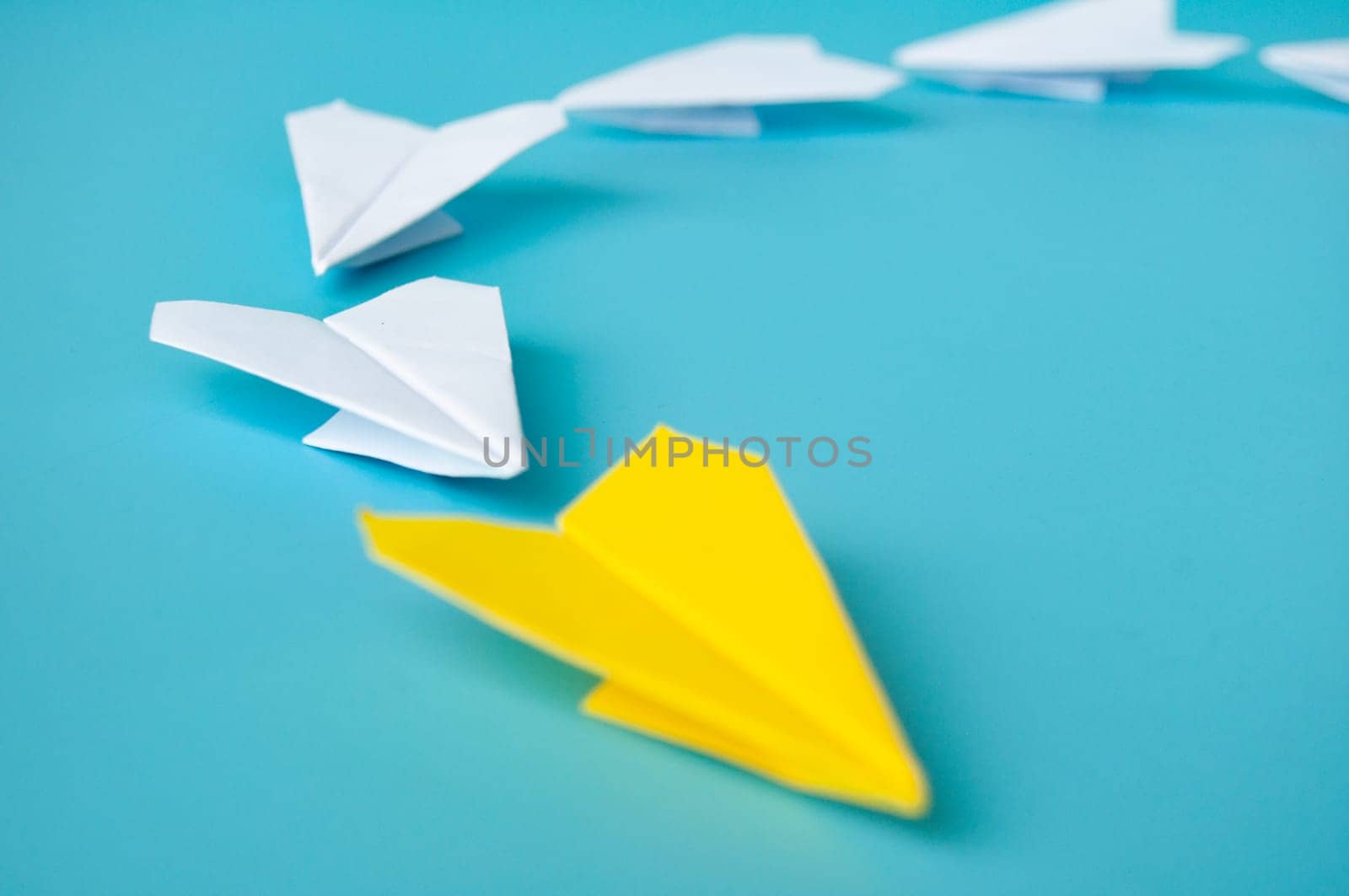 Top view of yellow paper airplanes with space for text.
